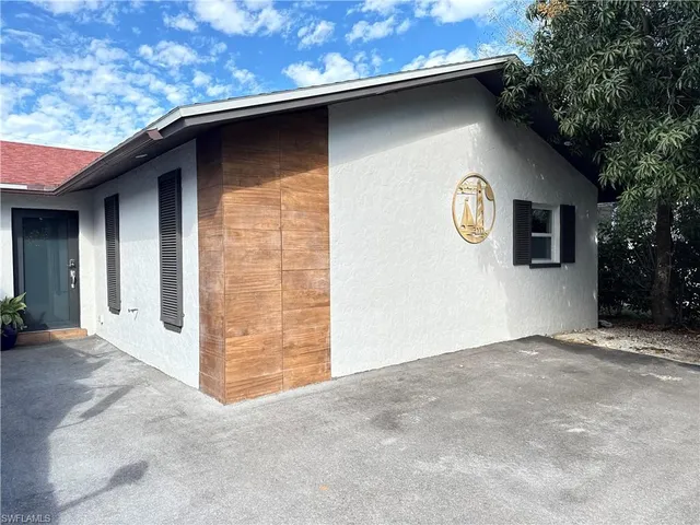 a view of a door of a house with a tree