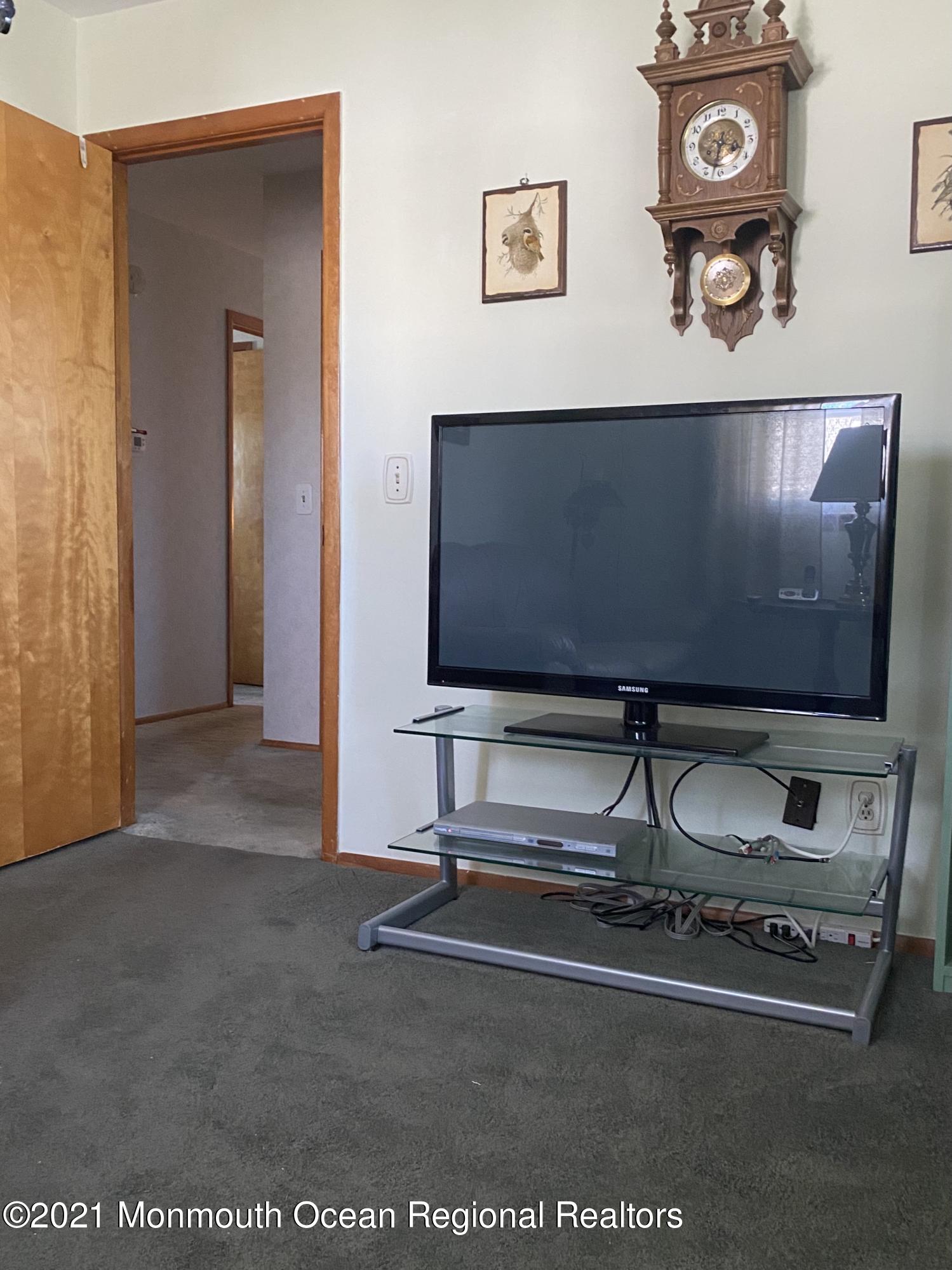 613 Ocean Road Spring Lake Heights, NJ 07762 - Photo 7 of 9 a room with gym equipment and view of living room