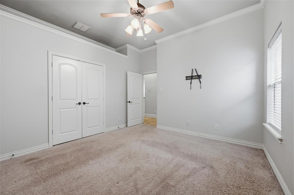 620 Highview Lane Hurst, TX 76054 - Photo 32 of 40 Carpeted room featuring crown molding, neutral wall tones, a ceiling fan with integrated lighting, and a window with blinds