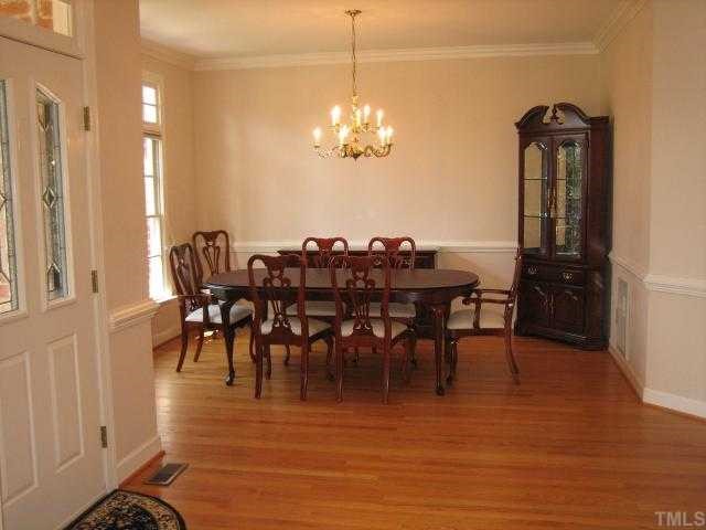 7928 Rooksley Court Raleigh, NC 27615 - Photo 3 of 12 Elegant dining room with wonderful windows and transoms, moldings, chair rail and perfect hardwood floors!