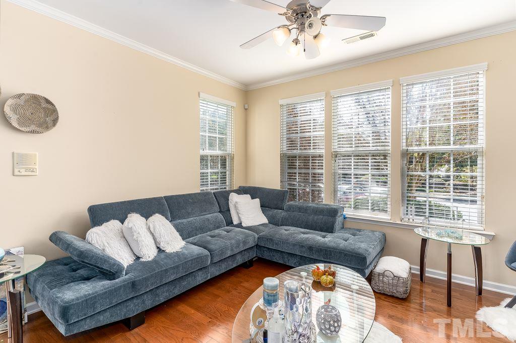 7606 Winners Edge Street Raleigh, NC 27617 - Photo 3 of 25 a living room with furniture and a large window