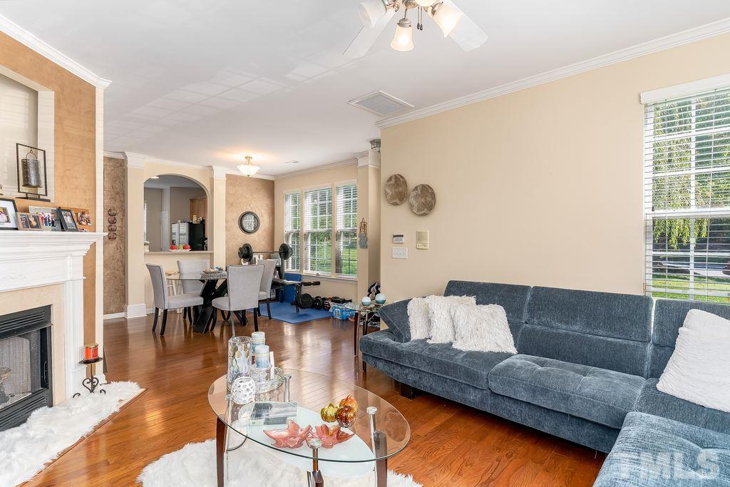7606 Winners Edge Street Raleigh, NC 27617 - Photo 4 of 25 a living room with furniture and a fireplace