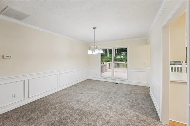 an empty room with windows and entrance