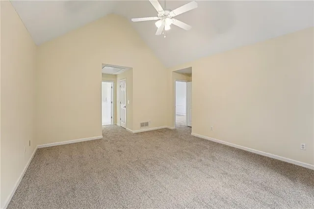 an empty room with fan and fan