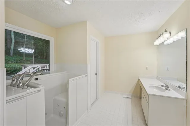a bathroom with a sink a toilet and shower curtain