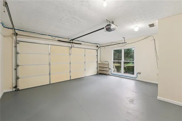 a view of a house with a yard and large trees