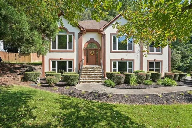 a front view of a house with garden