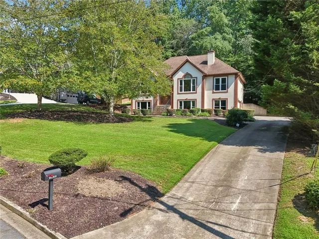 a front view of a house with garden