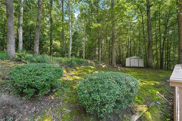 a view of a wooden deck and a yard with wooden fence