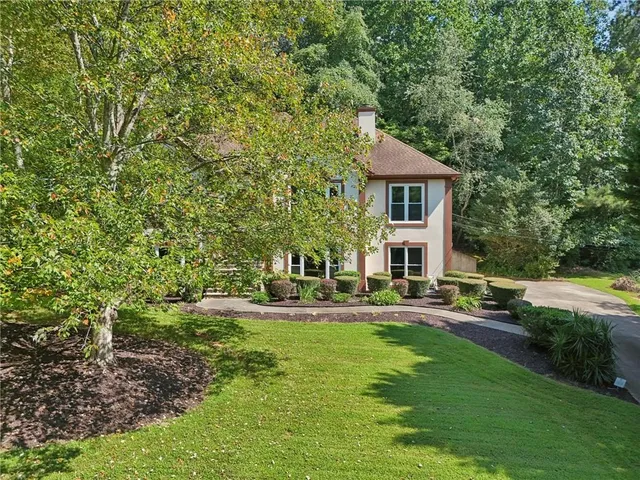 an aerial view of a house with a yard