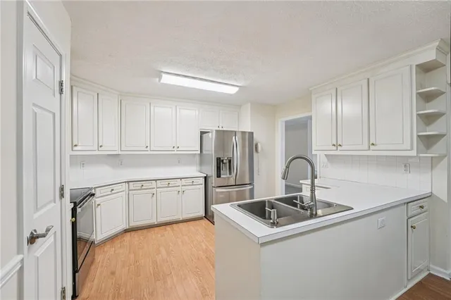 a kitchen with sink a stove and refrigerator