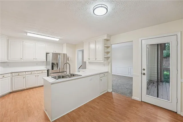a kitchen with stainless steel appliances a refrigerator sink and cabinets