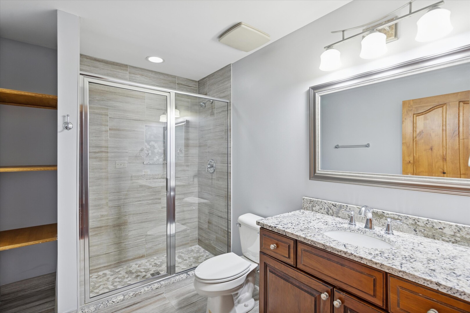 16W125 89th Street Burr Ridge, IL 60527 - Photo 9 of 15 a bathroom with a granite countertop sink toilet a mirror and shower