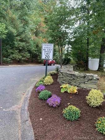 a sign that is in front of flowers