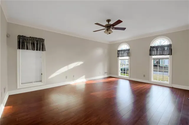 a kitchen with a stove a refrigerator and chairs