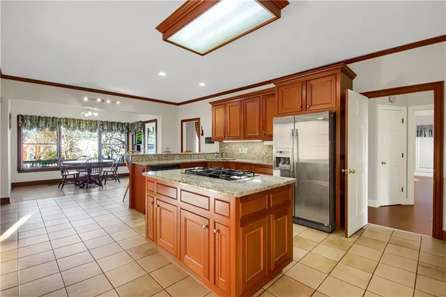 a bathroom with a granite countertop sink a mirror and a bathtub