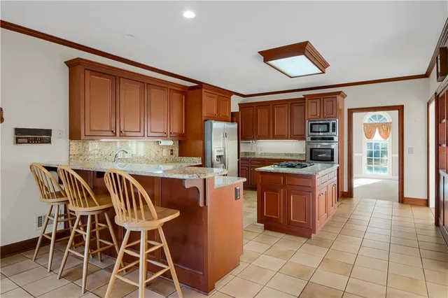an empty room with a chandelier fan and bathroom