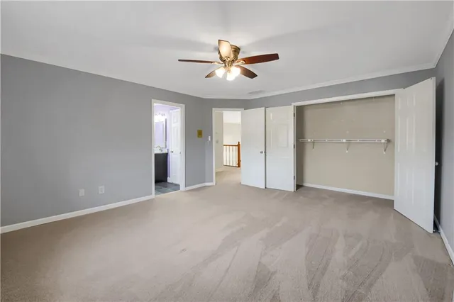 a view of a livingroom with a fireplace and a ceiling fan