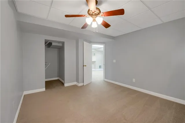a bathroom with a toilet and a rug