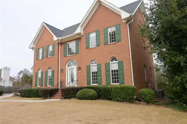 a view of staircase with white walls and railing