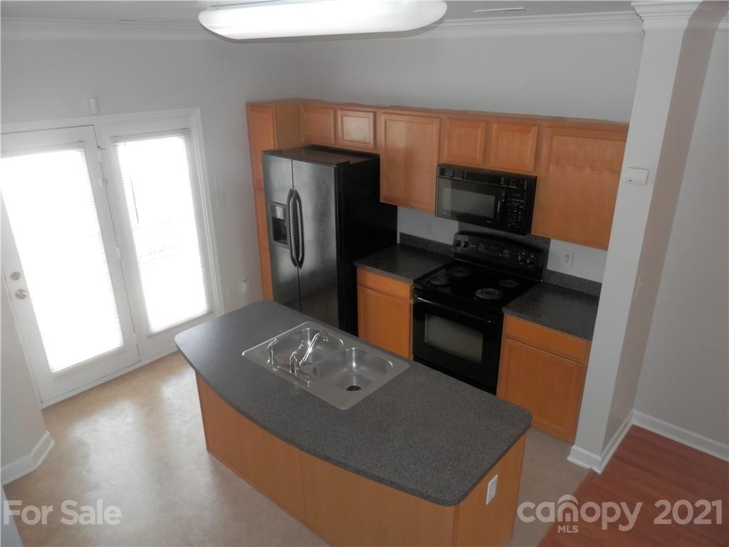 5057 Prosperity Church Road Charlotte, NC 28269 - Photo 14 of 24 a kitchen with stainless steel appliances a refrigerator a stove a microwave and a refrigerator