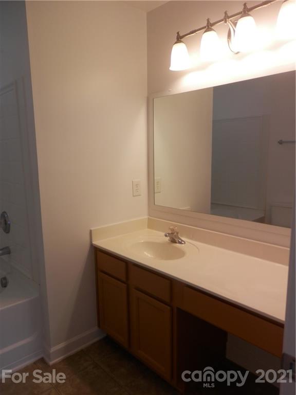 5057 Prosperity Church Road Charlotte, NC 28269 - Photo 18 of 24 a bathroom with a sink and a mirror