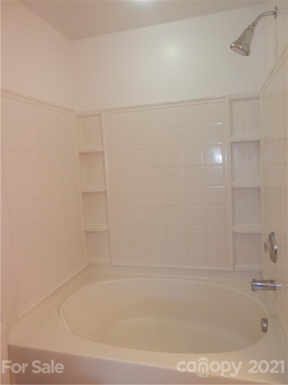 5057 Prosperity Church Road Charlotte, NC 28269 - Photo 19 of 24 a bathroom with a bathtub