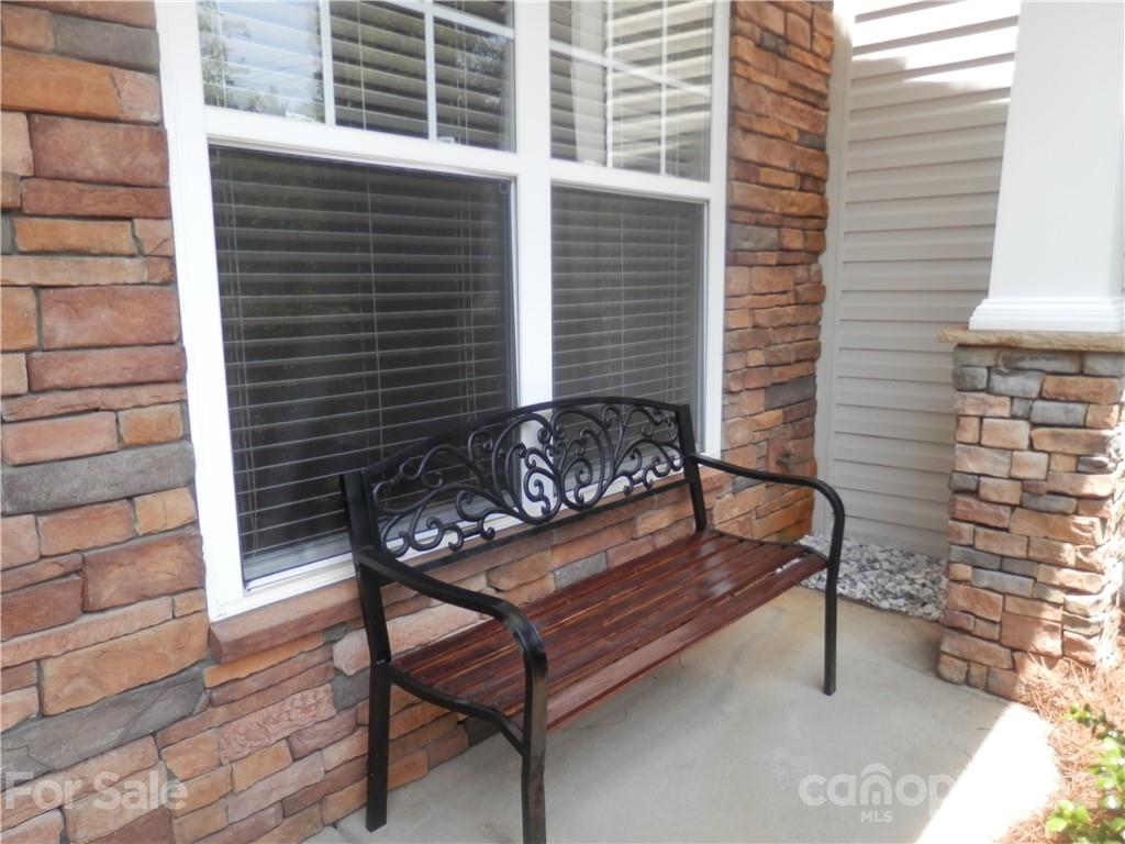 5057 Prosperity Church Road Charlotte, NC 28269 - Photo 3 of 24 a view of a wooden bench sitting area with furniture
