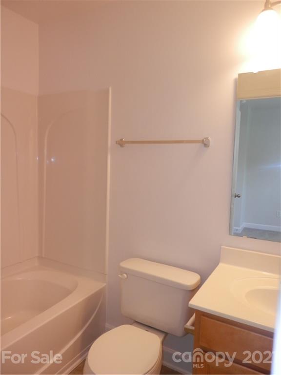 5057 Prosperity Church Road Charlotte, NC 28269 - Photo 22 of 24 a white toilet sitting next to a bath tub and a shower
