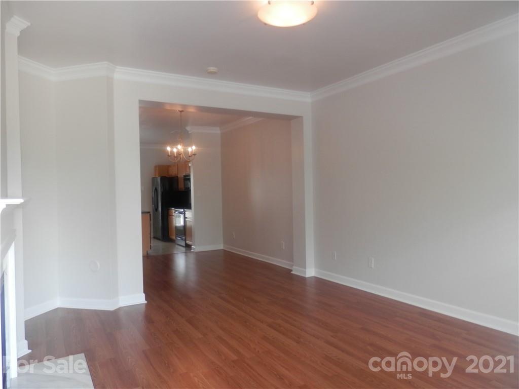 5057 Prosperity Church Road Charlotte, NC 28269 - Photo 5 of 24 a view of a hallway with wooden floor