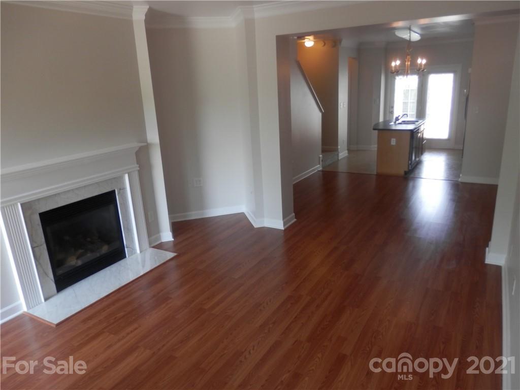 5057 Prosperity Church Road Charlotte, NC 28269 - Photo 6 of 24 a view of a hallway with wooden floor