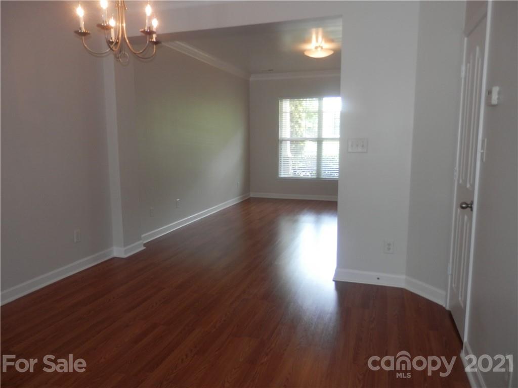 5057 Prosperity Church Road Charlotte, NC 28269 - Photo 7 of 24 wooden floor in an empty room with a window