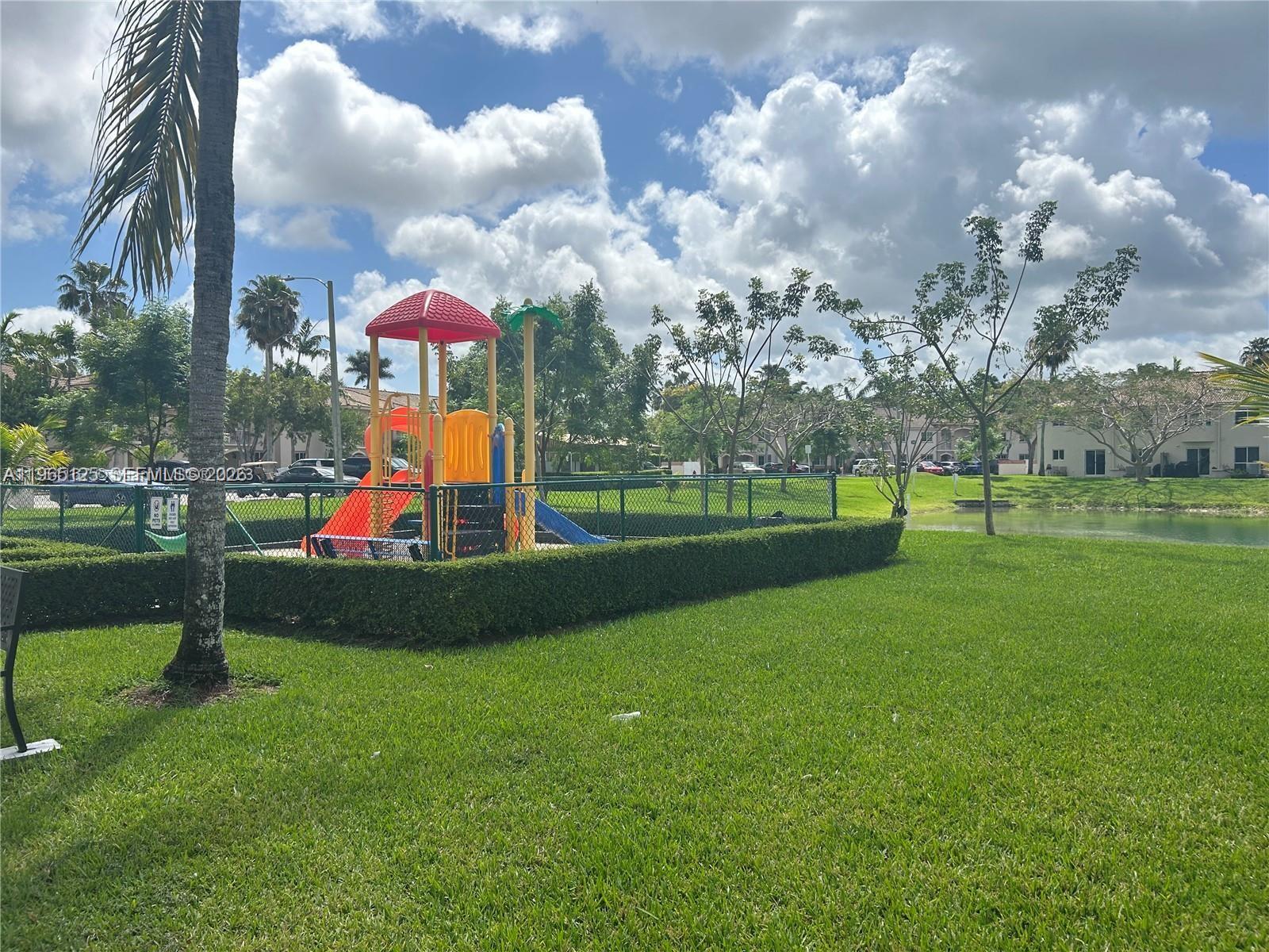 2621 Southeast 12th Road, Unit 106 Homestead, FL 33035 - Photo 2 of 4 a childrens park with lots of swings and slides