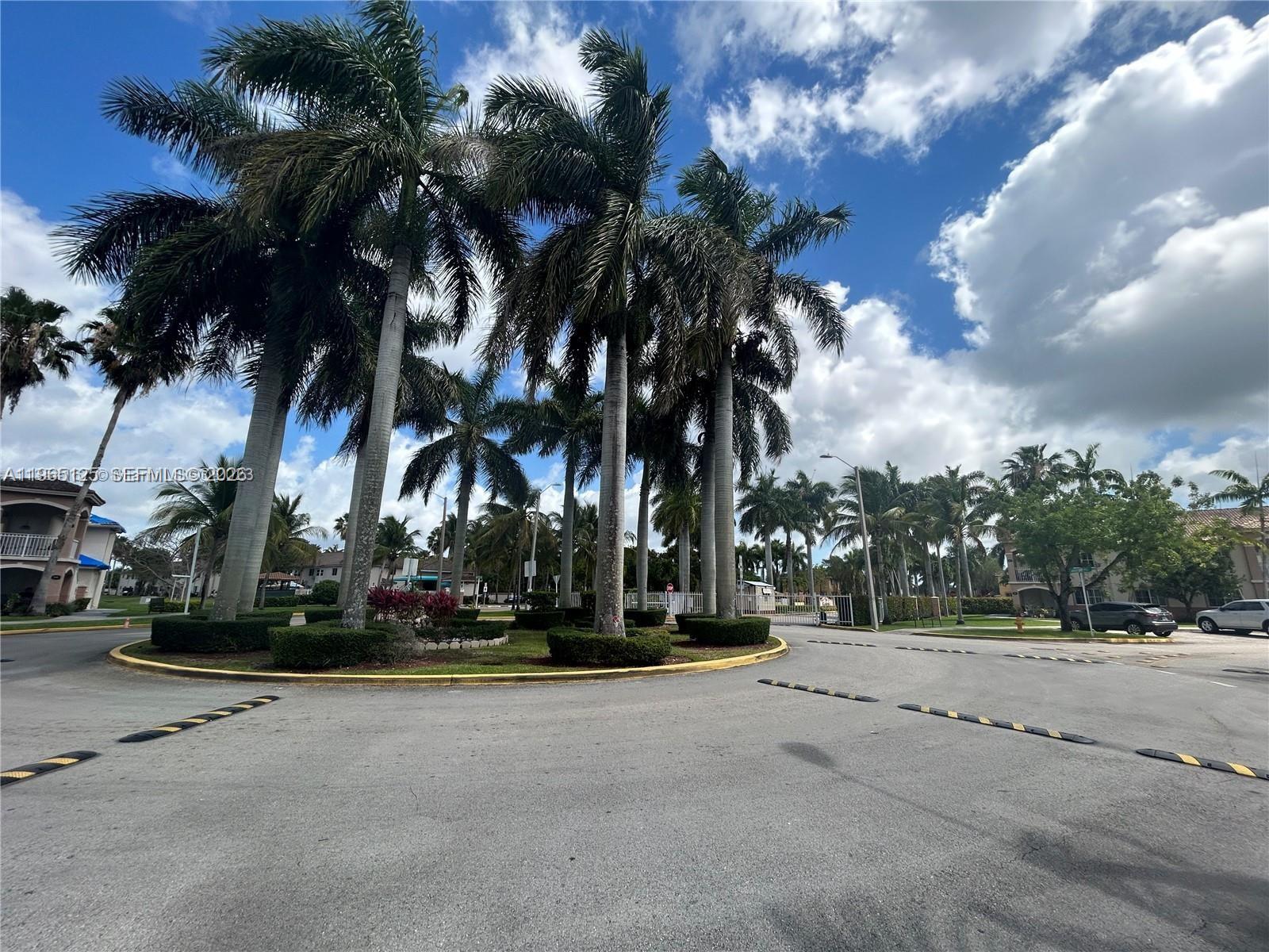 2621 Southeast 12th Road, Unit 106 Homestead, FL 33035 - Photo 3 of 4 a view of palm trees and a cars