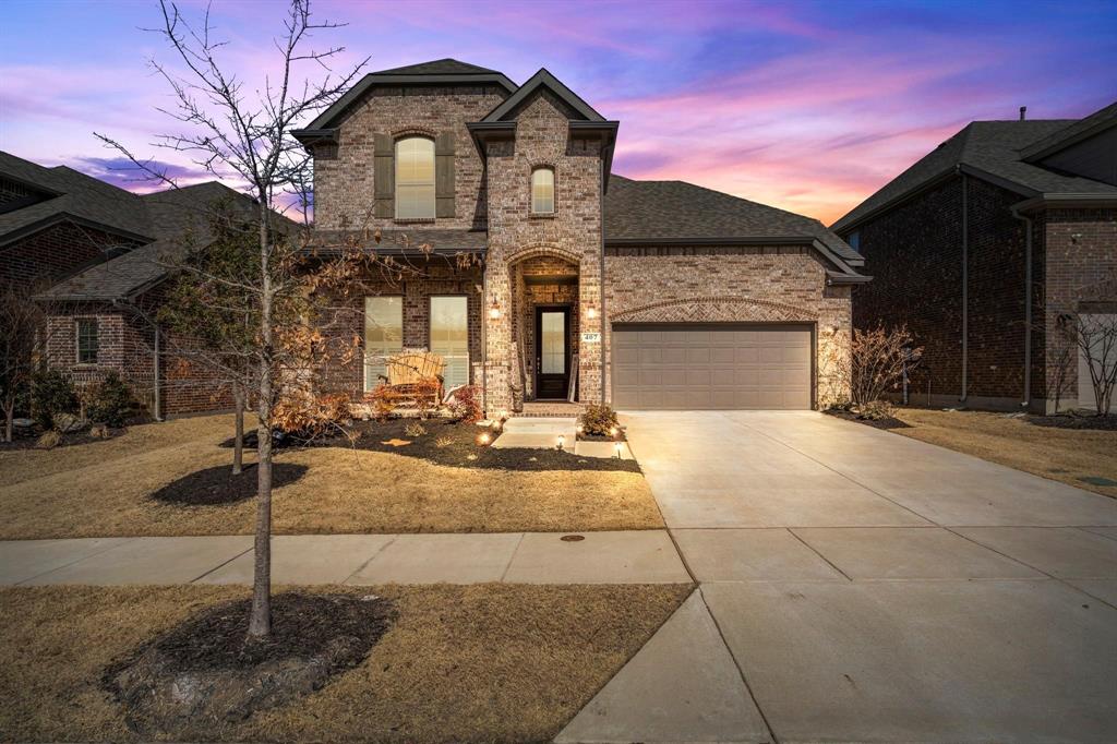 French provincial home featuring brick siding, concrete driveway, a garage, and a shingled roof