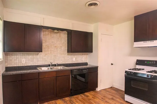 a kitchen with a sink stove and microwave