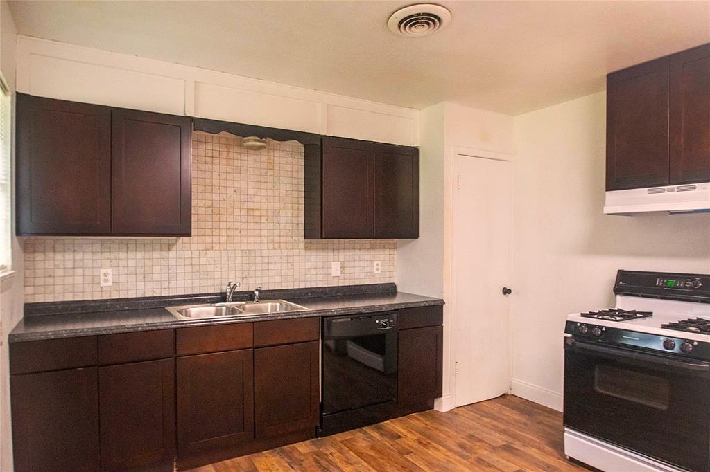 1709 Lattimore Street Denton, TX 76209 - Photo 3 of 23 a kitchen with a sink stove and microwave