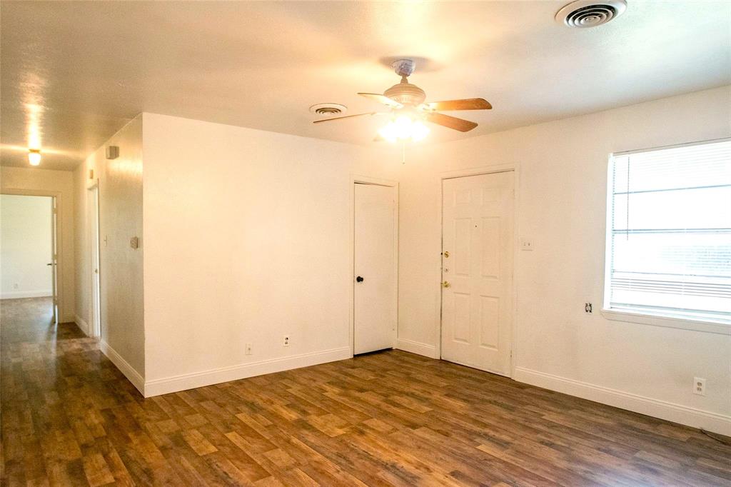 1709 Lattimore Street Denton, TX 76209 - Photo 5 of 23 an empty room with wooden floor and fan chandelier