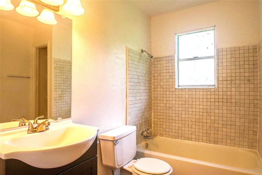 1709 Lattimore Street Denton, TX 76209 - Photo 8 of 23 a bathroom with a sink and a mirror