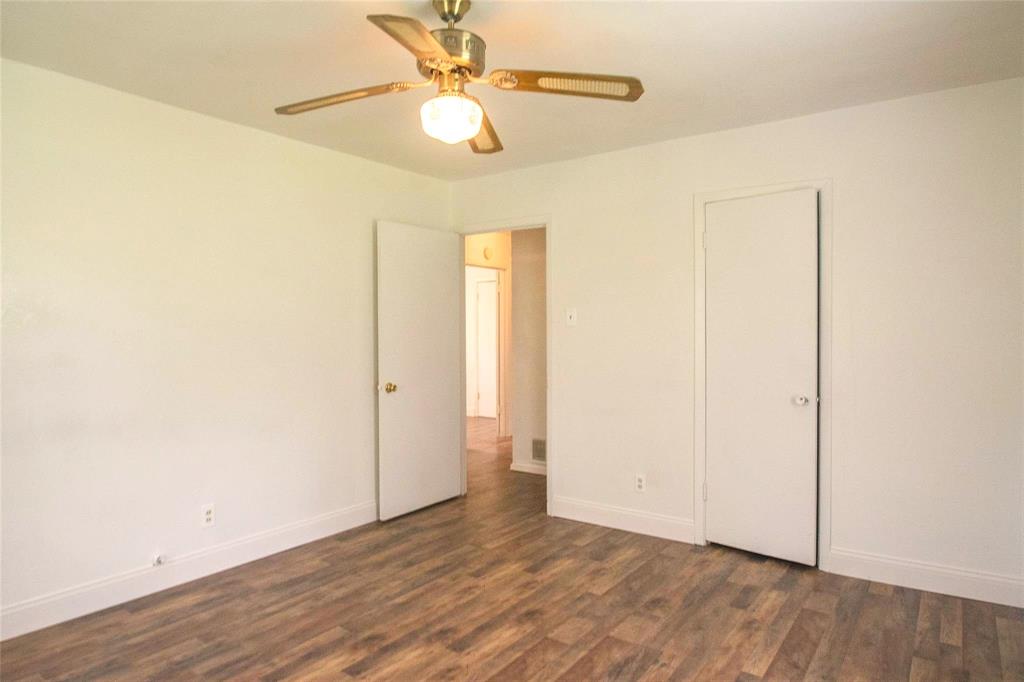 1709 Lattimore Street Denton, TX 76209 - Photo 9 of 23 an empty room with wooden floor and fan