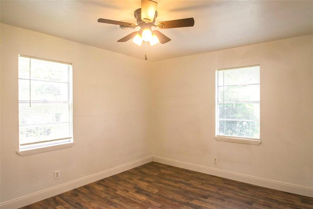 1709 Lattimore Street Denton, TX 76209 - Photo 10 of 23 an empty room with wooden floor ceiling fan and windows