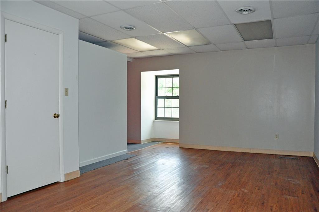 605 Freeport Road Aspinwall, PA 15215 - Photo 4 of 10 a view of an empty room with wooden floor and a window
