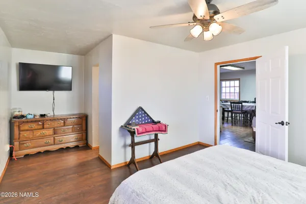 a bedroom with furniture and a flat screen tv