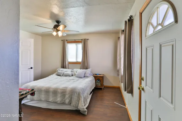 a bedroom with a bed a chandelier and a window