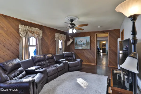 a living room with furniture a large window and a chandelier