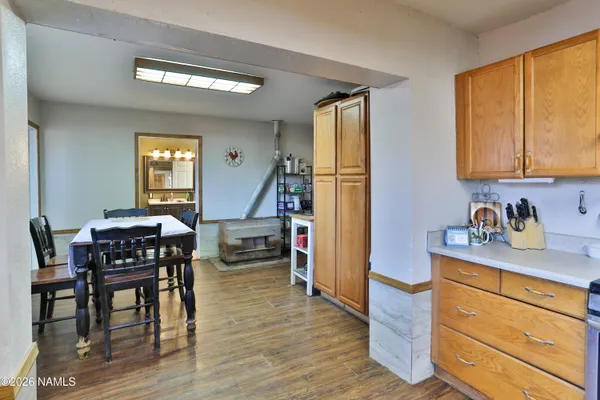 a view of a kitchen area with furniture and wooden floor