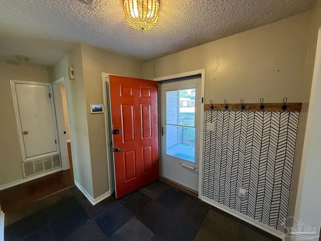 a view of a hallway with entryway door