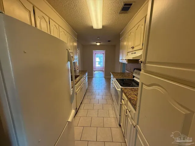 a hallway with washer and dryer