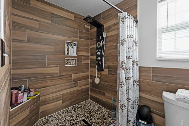 a bathroom with a toilet and shower