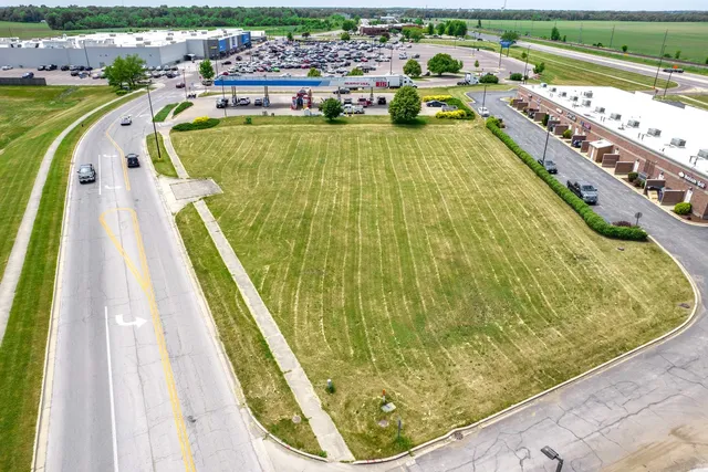 a view of a swimming pool with a garden and seating area